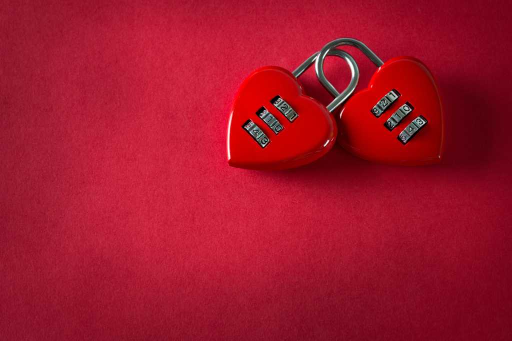 Two love combination padlock bonded together in red background
